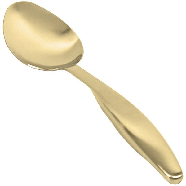 A close up of a Front of the House stainless steel serving spoon with a matte brass finish.