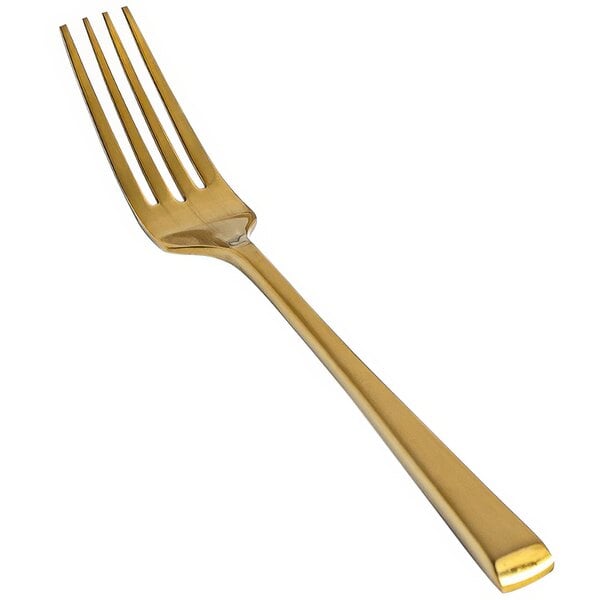 A close-up of a Front of the House Parker Matte Brass Salad/Dessert Fork.