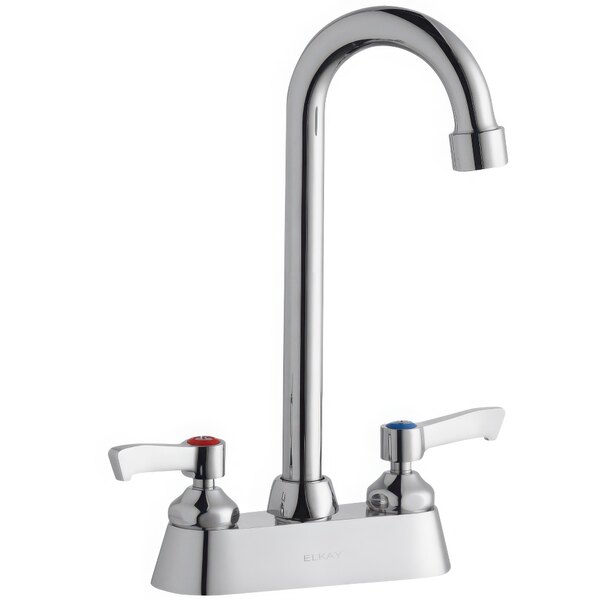 A silver Zurn Elkay deck-mount faucet with 2 gooseneck spouts and 2 lever handles.