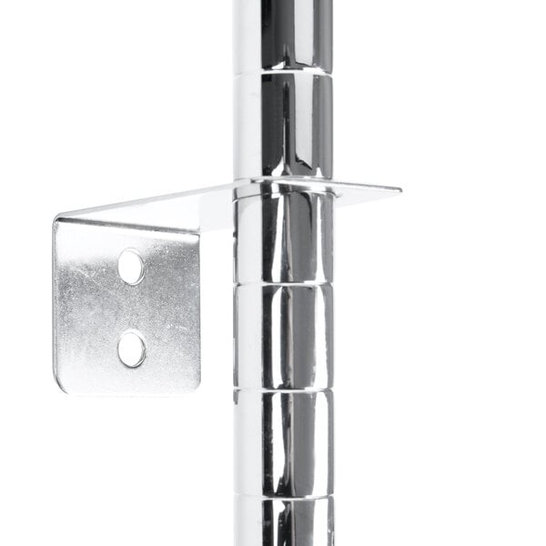 A Metro chrome metal wall mount bracket with a hole.