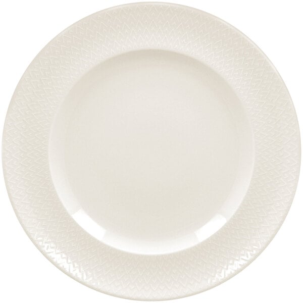 A close up of a RAK Porcelain ivory flat plate with a zigzag pattern.