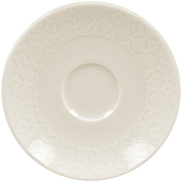 A white porcelain saucer with a circular pattern.