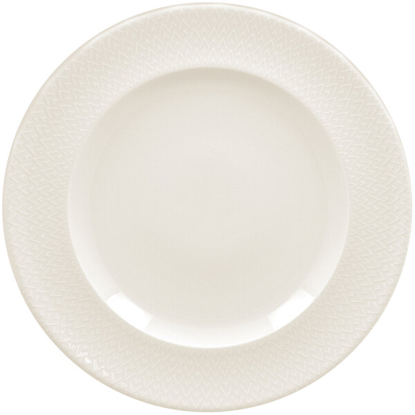 A white RAK Porcelain flat plate with a zigzag pattern on the rim.