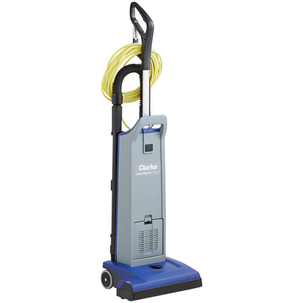 A blue and grey Clarke CarpetMaster 115 upright vacuum cleaner with a yellow hose.