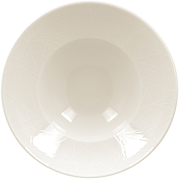 A close up of a RAK Porcelain ivory embossed porcelain plate with a pattern on the rim.