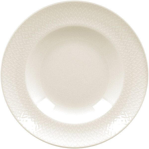 A close up of a RAK Porcelain ivory flat plate with an embossed circular pattern.