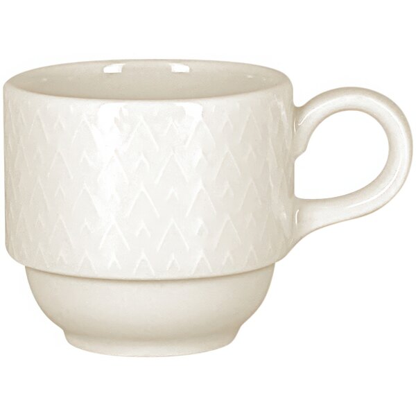 A white porcelain cup with an embossed design and a handle.
