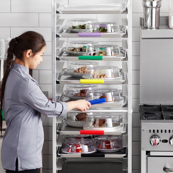 A woman using a Baker's Mark silicone bun tray to serve food.