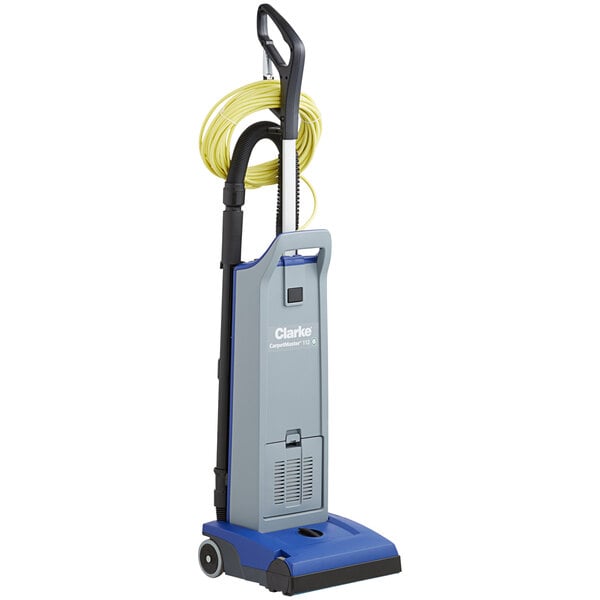 A blue and grey Clarke CarpetMaster upright vacuum cleaner with a hose.