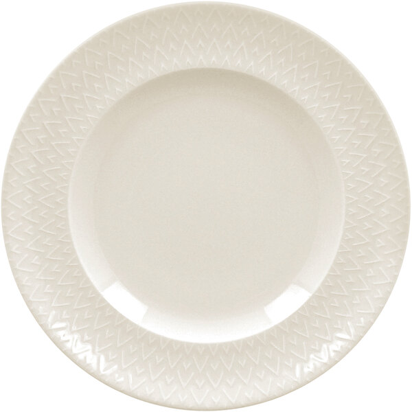 A close-up of a RAK Porcelain ivory flat plate with a zigzag pattern.