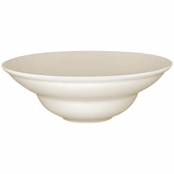 A close-up of a RAK Porcelain ivory extra deep plate with an embossed pattern.