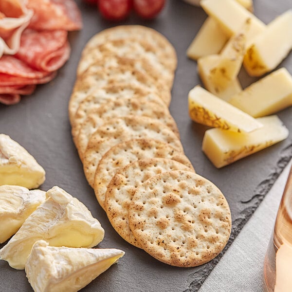 Carr's Table Water Roasted Garlic and Herb Crackers on a cheese and crackers platter.