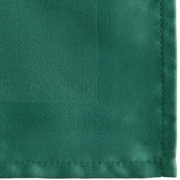 A forest green cloth napkin with a square edge and a white satin border.