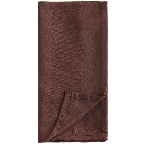 A brown napkin folded on a white background.