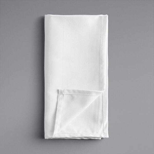 A white cloth folded on a gray surface.