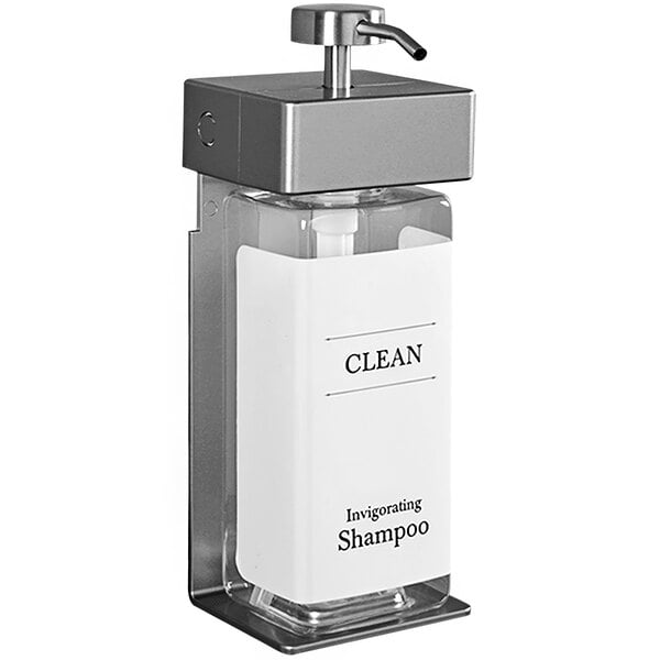 A white Dispenser Amenities Solera wall mounted shower dispenser with rectangular bottle in it.