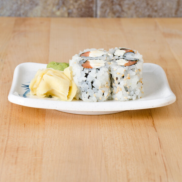 A Thunder Group Blue Bamboo rectangular melamine plate with sushi on it.