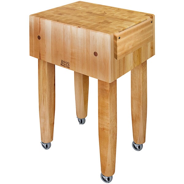 A John Boos maple wood butcher block table with casters.