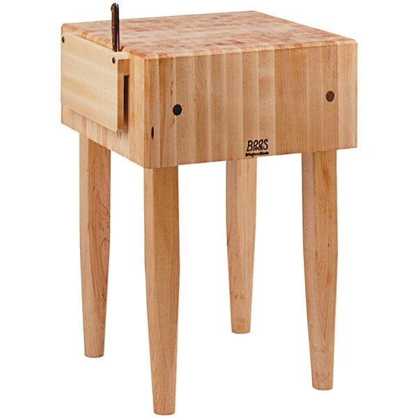 A John Boos maple butcher block table with a knife holder.