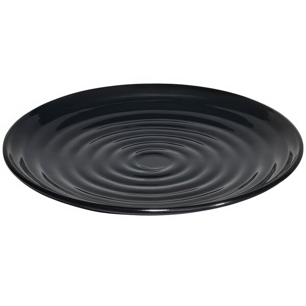 A black GET Milano melamine plate with ripples on it.