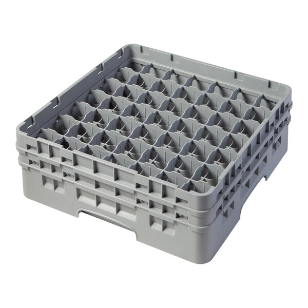 A soft gray plastic Cambro glass rack with many small compartments.