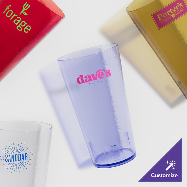 A variety of clear plastic pebbled tumblers with text on them.