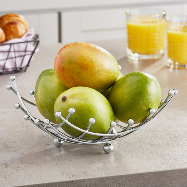 An American Metalcraft chrome square checker basket holding mangoes.