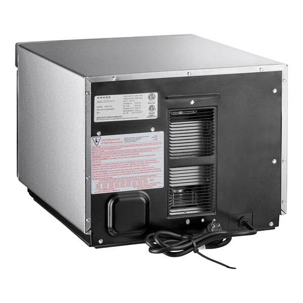 A black and silver rectangular Amana HDC212 commercial microwave with a black cord.