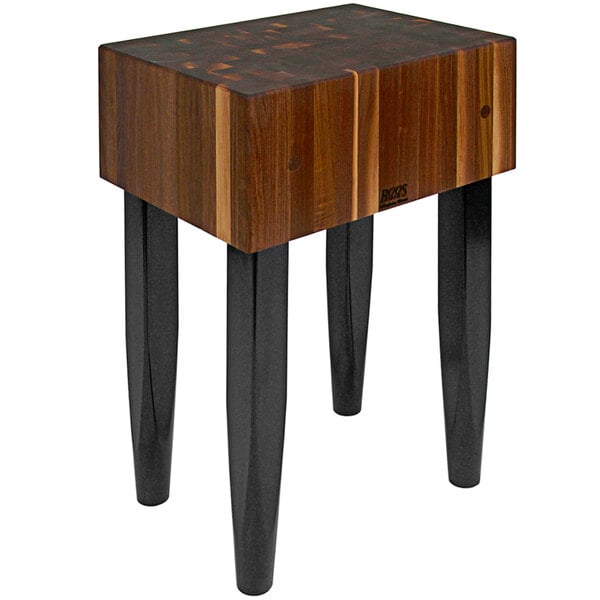 A John Boos walnut butcher block table with black legs.