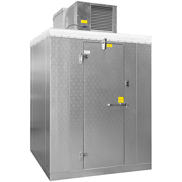 A large grey metal Master-Bilt outdoor walk-in cooler with a door open.