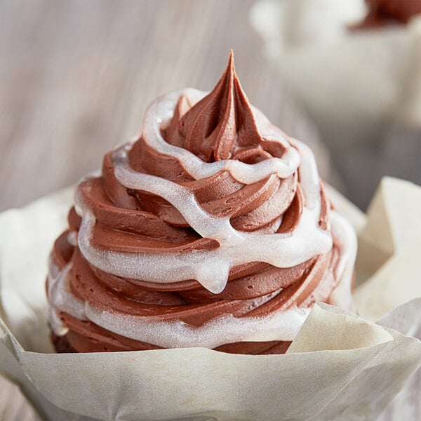 A chocolate cupcake with Satin Ice Pearl Vanilla Glitter Glaze on top.