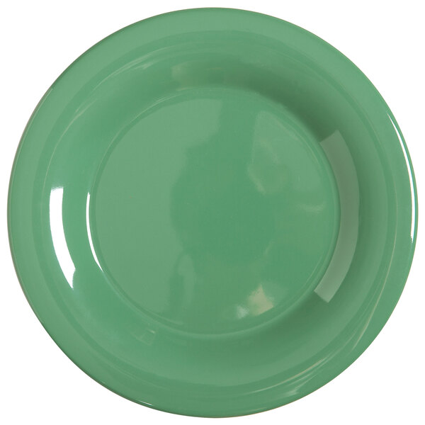 A close-up of a GET Diamond Mardi Gras rainforest green melamine plate with a white edge.