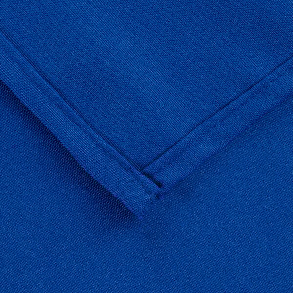 A close up of a royal blue hemmed fabric square.