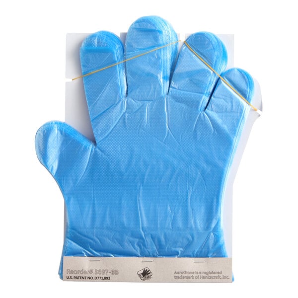 A blue disposable glove is displayed flat on a white background, still attached to its packaging with a rubber band across the top.