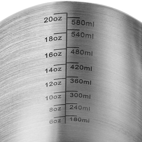 An Acopa stainless steel frothing pitcher with measuring lines.