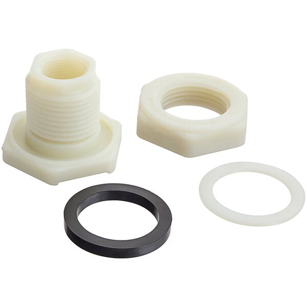 A white plastic nut and black ring with a hole in it.