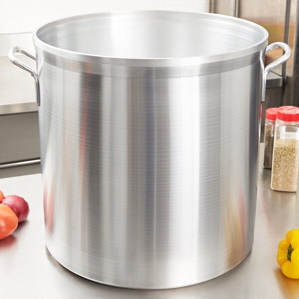 A Vollrath heavy duty aluminum stock pot on a counter.