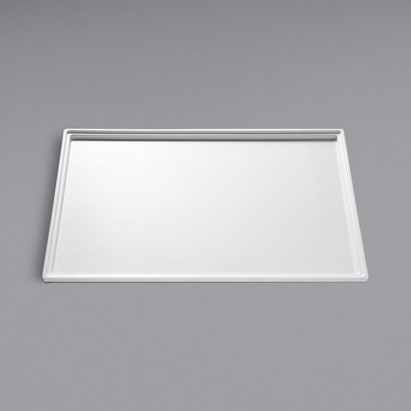 A white rectangular tray on a gray surface.