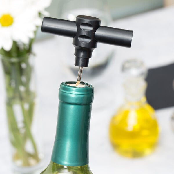 A Franmara black plastic pocket corkscrew opening a bottle