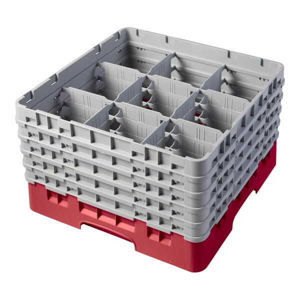 A red plastic Cambro glass rack with 9 compartments and 5 gray extenders.