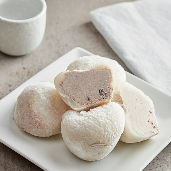 A white plate with My/Mochi Cookies and Cream Mochi Ice Cream on it.