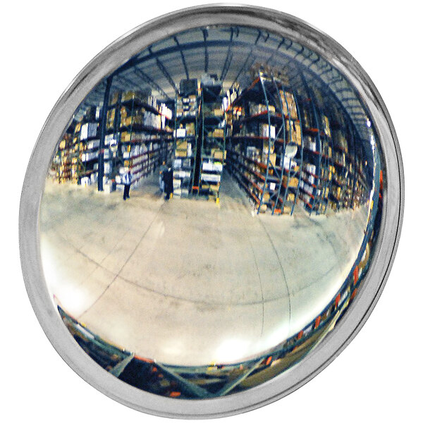 A Vestil indoor round convex mirror with a reflection of a warehouse full of boxes.