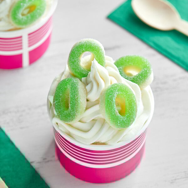 A cup of ice cream with Kervan Gummy Apple Rings on top.