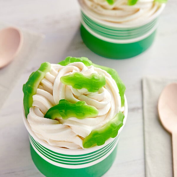 A cup of ice cream with green Kervan Gummy Crocodiles.