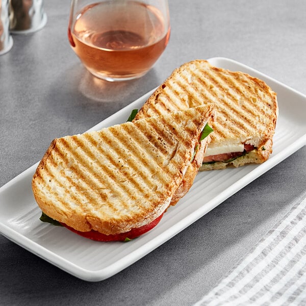 A grilled sandwich made with Turano Rustic Panini Bread on a plate.