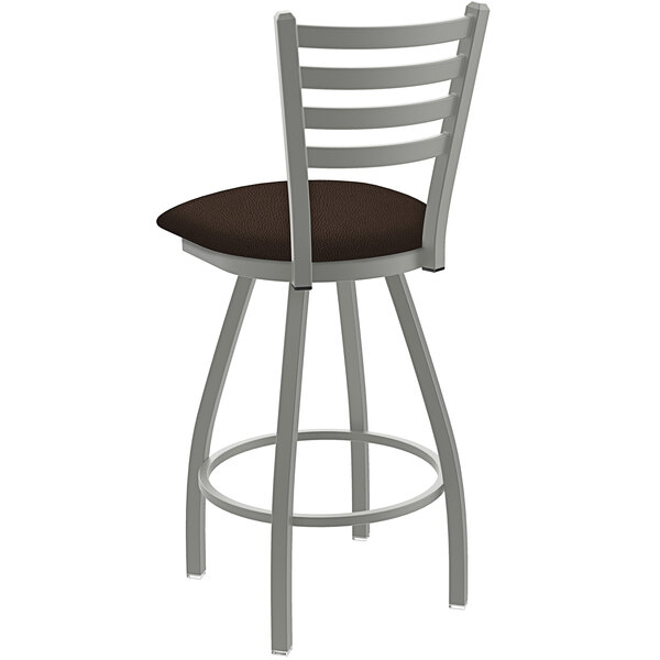 A white bar stool with a brown cushion and ladderback.
