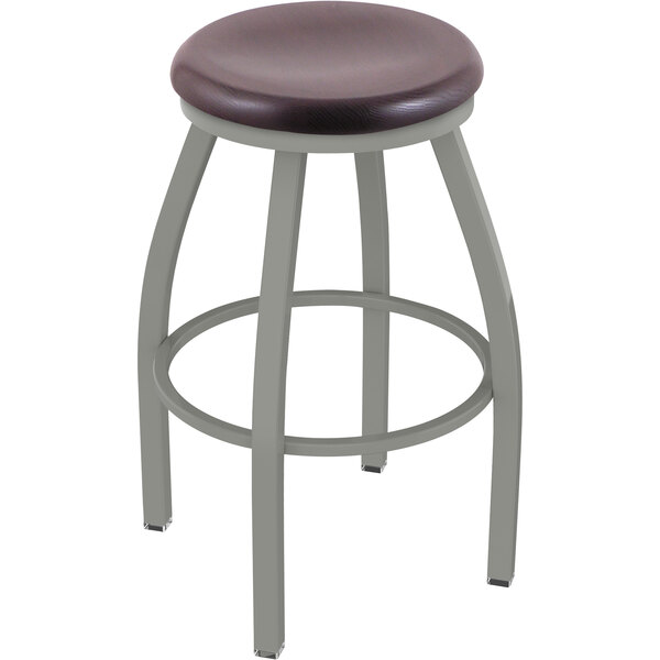 A Holland Bar Stool Misha Ladderback Swivel Bar Stool with a dark cherry oak seat.