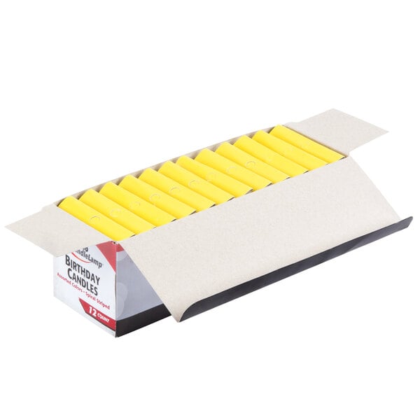 A white box with yellow and black writing containing 12 boxes of Sterno multi-colored birthday candles.