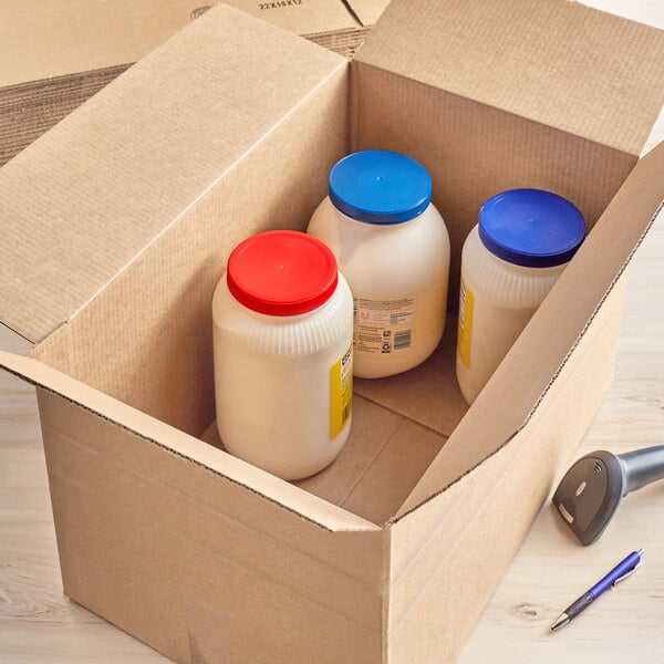 A Lavex corrugated shipping box with white containers and blue lids inside.