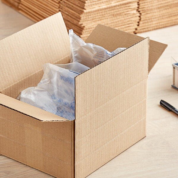 A Lavex kraft cardboard shipping box with a plastic bag inside.